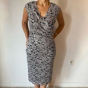 Silver and black dress with scalloped edging along neckline.